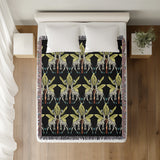 Kossy Giraffe Cotton Blend Blanket Throw in Black and Green, on a bed
