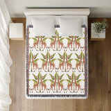 Kossy Giraffe Cotton Blend Blanket Throw in Green, Burnt Orange and Off-White, on a bed