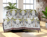 Kossy Giraffe Cotton Blend Blanket Throw in Gray, Green and Off-White, draped over a chair