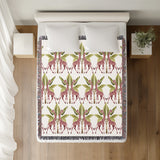 Kossy Giraffe Cotton Blend Blanket Throw in Pink, Green and Off-White, on a bed