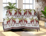 Kossy Giraffe Cotton Blend Blanket Throw in Red, Green and Off-White, draped over a chair