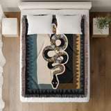 Kotu Snake Cotton Blend Blanket Throw in Black, Brown and Blue, on a bed