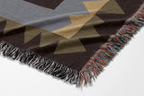 Kotu Snake Cotton Blend Blanket Throw in Brown, Beige and Gray, draped over a chair
