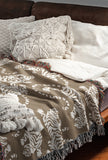Leonard Tiger Cotton Blend Blanket Throw in Beige and Off-White, draped over a chair