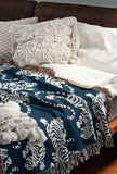 Leonard Tiger Cotton Blend Blanket Throw in Blue and Off-White, draped over a chair