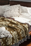 Leonard Tiger Cotton Blend Blanket Throw in Brown and Off-White, draped over a chair