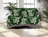 Leonard Tiger Cotton Blend Blanket Throw in Green and Off-White, draped over a chair
