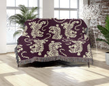 Leonard Tiger Cotton Blend Blanket Throw in Purple and Off-White, draped over a chair