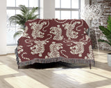 Leonard Tiger Cotton Blend Blanket Throw in Red and Off-White, draped over a chair