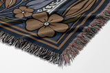 Lim Elephant Cotton Blend Blanket Throw in Black, Blue and Red, draped over a chair