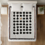 Lissa Dots Abstract Cotton Blend Blanket Throw in Beige, Black and Off-White, on a bed