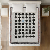 Lissa Dots Abstract Cotton Blend Blanket Throw in Blue, Black and Off-White, on a bed