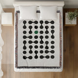 Lissa Dots Abstract Cotton Blend Blanket Throw in Green, Black and Off-White, on a bed