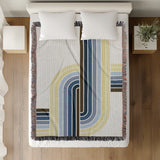 Merna Cotton Blend Blanket Throw in Blue, on a bed