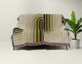 Merna Cotton Blend Blanket Throw in Chartreuse, draped over a chair