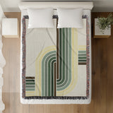 Merna Cotton Blend Blanket Throw in Green, on a bed