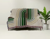 Merna Cotton Blend Blanket Throw in Green, draped over a chair