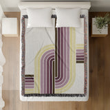Merna Cotton Blend Blanket Throw in Purple, on a bed