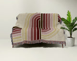 Merna Cotton Blend Blanket Throw in Red, draped over a chair