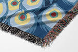Nivo Peacock Cotton Blend Blanket Throw in Blue, on a bed