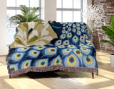 Nivo Peacock Cotton Blend Blanket Throw in Blue, draped over a chair