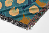 Nivo Peacock Cotton Blend Blanket Throw in Dark Turquoise, on a bed
