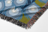 Nivo Peacock Cotton Blend Blanket Throw in Light Blue, on a bed