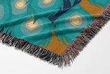 Nivo Peacock Cotton Blend Blanket Throw in Teal, on a bed