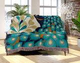 Nivo Peacock Cotton Blend Blanket Throw in Teal, draped over a chair