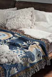 Piya Peacock Cotton Blend Blanket Throw in Blue, on a bed