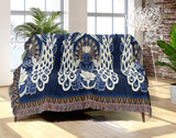 Piya Peacock Cotton Blend Blanket Throw in Blue, draped over a chair