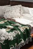 Ren Leopard Cotton Blend Blanket Throw in Green and Off-White, on a bed