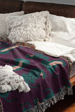Ren Leopard Cotton Blend Blanket Throw in Purple and Teal, on a bed