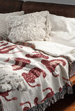 Ren Leopard Cotton Blend Blanket Throw in Red, Pink and Off-White, on a bed