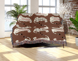 Ren Leopard Cotton Blend Blanket Throw in Rust Brown and Off-White, on a bed