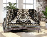 Roy Tiger Cotton Blend Blanket Throw in Black, draped over a chair