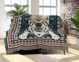 Roy Tiger Cotton Blend Blanket Throw in Blue, draped over a chair