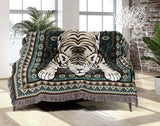 Roy Tiger Cotton Blend Blanket Throw in Emerald, draped over a chair