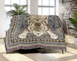 Roy Tiger Cotton Blend Blanket Throw in Gray, draped over a chair