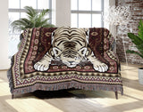 Roy Tiger Cotton Blend Blanket Throw in Red, draped over a chair