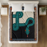 Sami Snake Cotton Blend Blanket Throw in Teal and Black, on a bed
