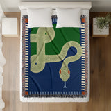 Sami Snake Cotton Blend Blanket Throw in Blue and Green, on a bed