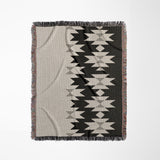 Shako Southwestern Cotton Blend Blanket Throw in Black, Gray and Off-White, on a bed