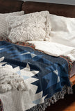 Shako Southwestern Cotton Blend Blanket Throw in Blue and Off-White, draped over a chair