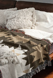 Shako Southwestern Cotton Blend Blanket Throw in Brown and Off-White, draped over a chair