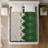 Shako Southwestern Cotton Blend Blanket Throw in Green and Off-White, on a bed