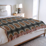 Speck Cotton Blend Blanket Throw in Burnt Orange, on a bed