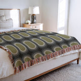 Speck Cotton Blend Blanket Throw in Chartreuse, on a bed