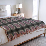 Speck Cotton Blend Blanket Throw in Purple, on a bed