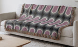 Speck Cotton Blend Blanket Throw in Purple, draped over a chair